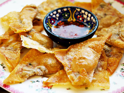 陶制中式泰式馄饨配肉末和糖醋汁.照片