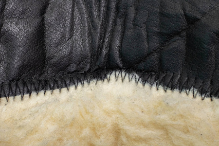 皮革和毛皮服装上的特写缝线照片