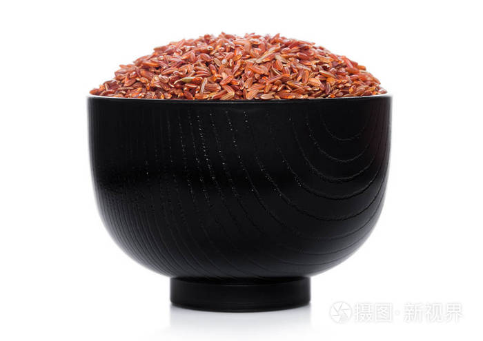 Black bowl of raw organic red rice on white background. Healthy 