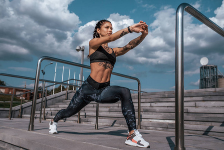 在城市的夏天,锻炼腿部肌肉,健身前先热身,在城市里锻炼后再慢跑.照片