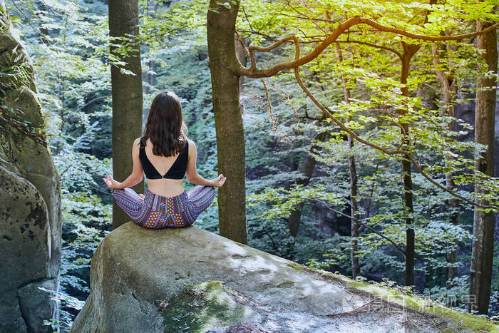 小女孩在森林里冥想和做瑜伽