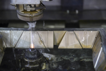 the wire edm machine cutting  the mould parts  lubricant fluid.