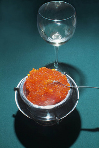 绿色餐桌上的红色(鲑鱼)鱼子酱照片