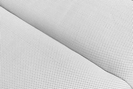 现代豪华轿车白色真皮内饰.部分穿孔真皮汽车座椅细节.