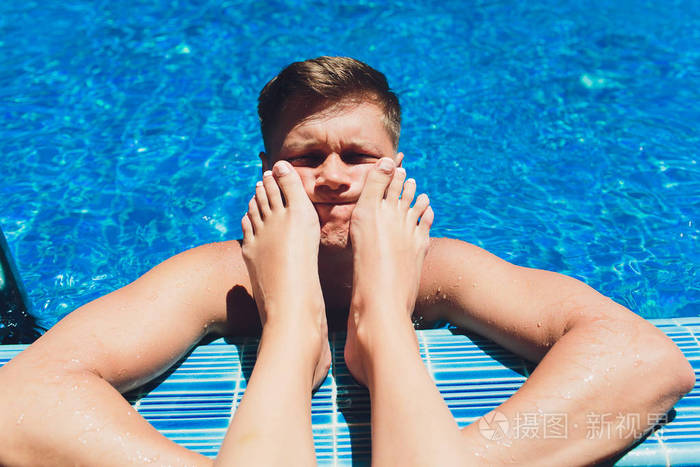 男人女人的腿游泳池脚放在脸上怕老婆的概念
