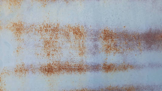 锈迹斑斑的金属墙,旧铁皮上覆盖着铁锈照片
