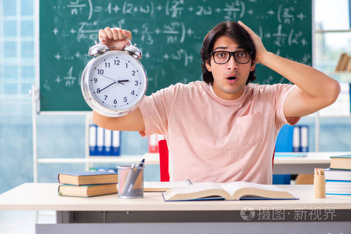 Young male student in the classroom 