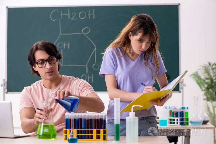 Two chemists students in classroom 