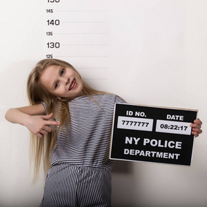 充电线海报一个年轻漂亮的金发小孩,拿着一个牌子,一张犯罪照片.