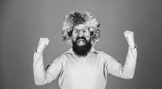 留着胡子的男人戴着五颜六色的假发,戴着有趣的紫色背景眼镜.