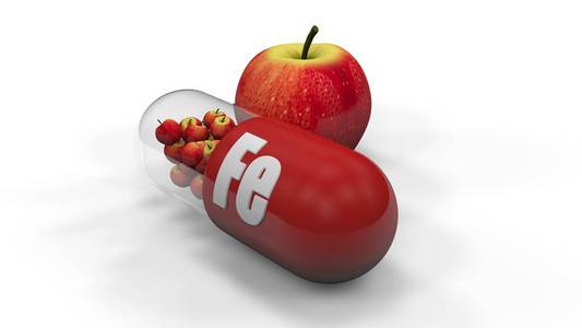 铁药片一个含有微量元素铁的胶囊,药丸的苹果的3d插图.