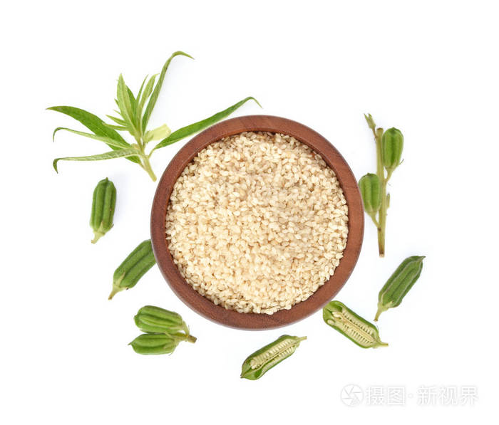 Top view of white sesame seeds in wooden bowl isolated on white 