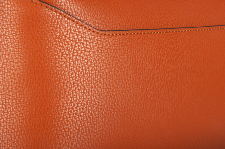 皮革线一块缝线整齐的单色橙色皮革照片