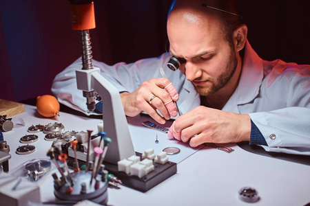 这位经验丰富的制表师正在他的工作室为卡斯特默斯手表雕刻照片