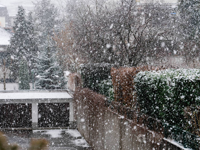 Snow falling over interior courtyard 