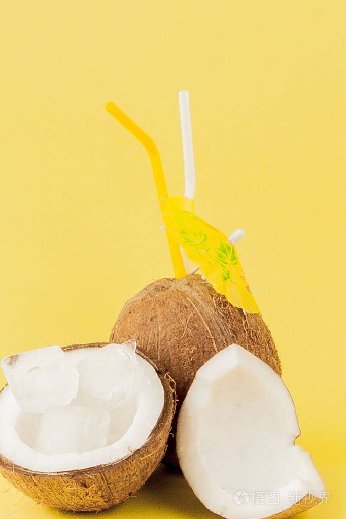 freshcoconutcocktailwithastrawsonyellowbackgroundcopy