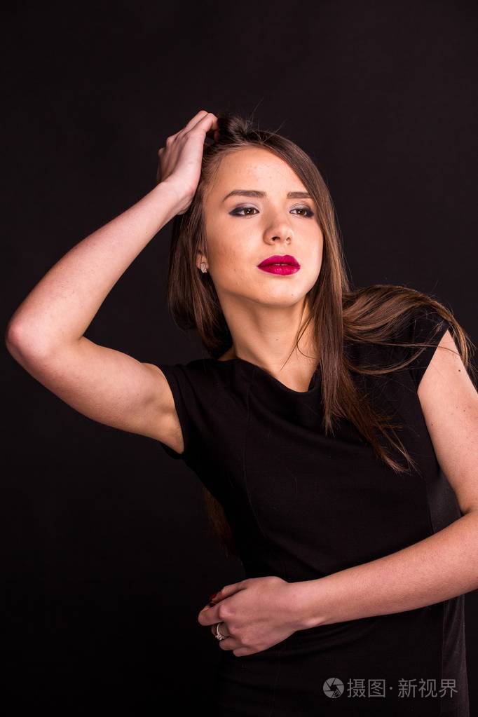 一位美丽的年轻女子的画像,身穿黑色连衣裙,妆容清凉,皮肤很好.