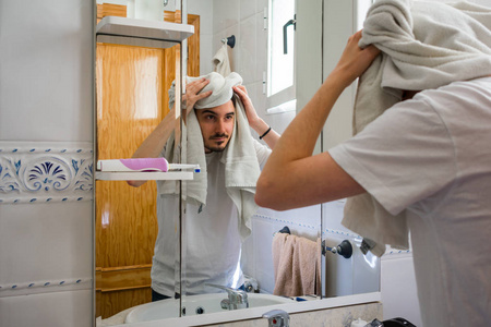 他正在用毛巾擦干头发.照片