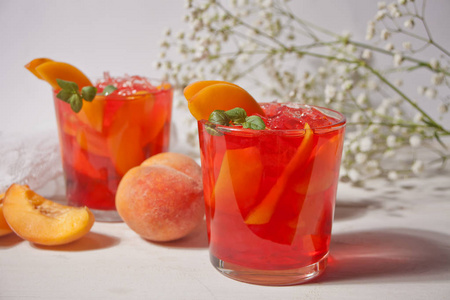 一杯新鲜的自制桃子甜冰茶或鸡尾酒,柠檬水薄荷.清凉的冷饮.夏季聚会.