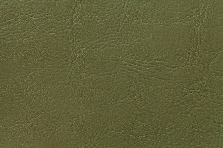 深橄榄色皮革纹理背景,特写.绿色裂缝背景照片