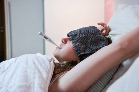 生病的少女发高烧.照片