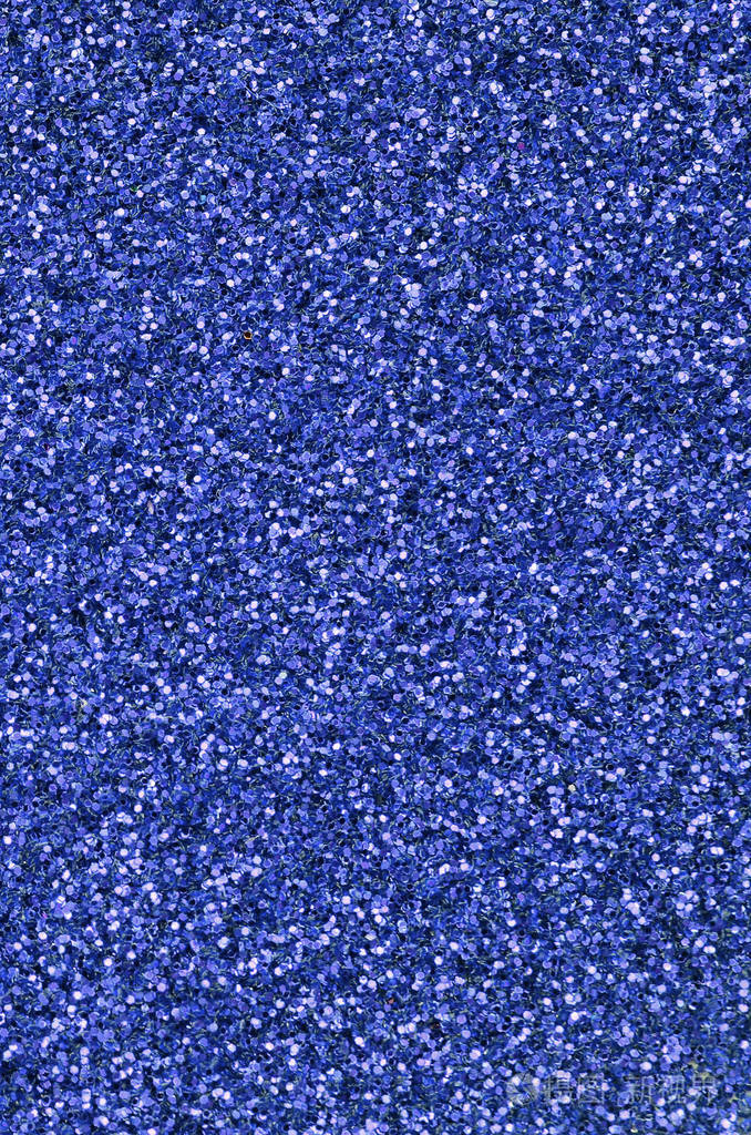 蓝色装饰亮片背景图像中有来自小元素的闪亮的bokeh光