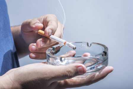 玻璃烟灰缸拿着烟灰缸玻璃抽烟的人照片