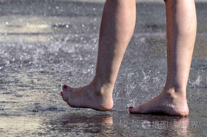 在雨中赤脚走过水坑
