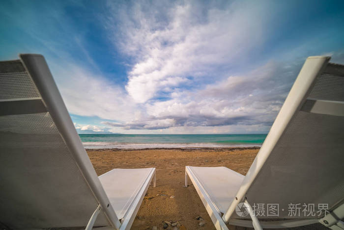 Empty white plastic sunbeds on Tsilivi Beach