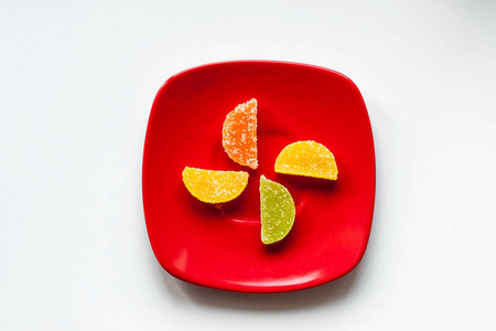 红盘子里放四颗糖糖照片