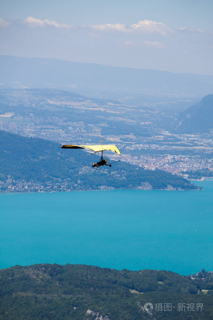 hang-glider instructor flying in hang-glider with customer over