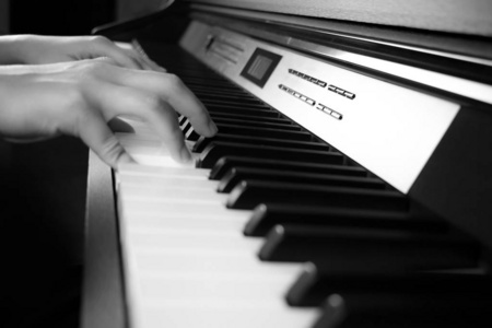 欧美爵士背景图年轻的手在弹钢琴.侧视图照片