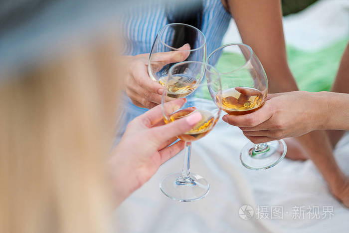 三个女人手拿着一杯白葡萄酒干杯祝贺你有一次户外