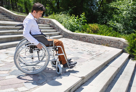 坐轮椅不能下楼梯的年轻人.照片