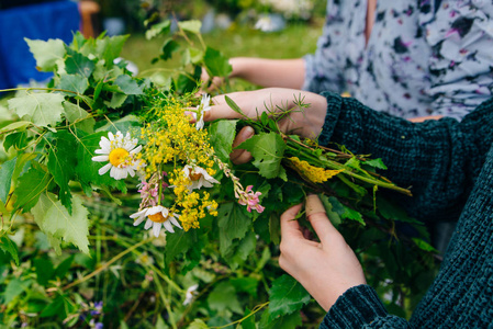 用花绳编桃心女孩用野花和草地在头上编了一个花环照片