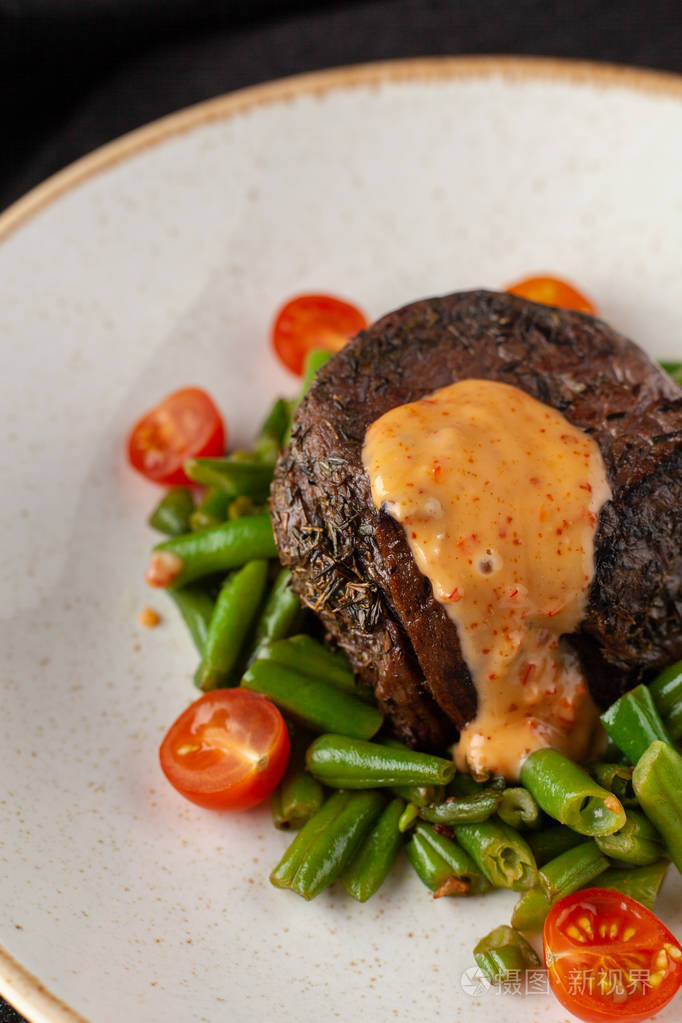 closeupviewofamediumraremignonsteakroastedwithgreen