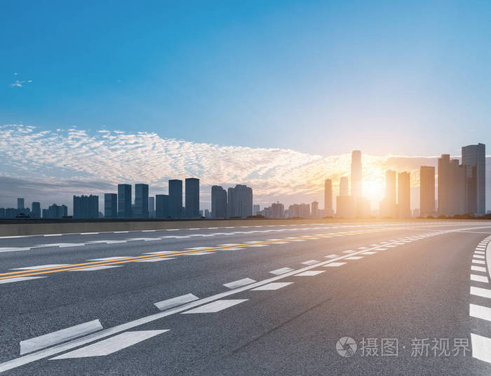 日出中的道路与现代城市天际线