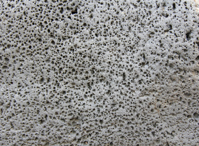 火山熔岩灰色岩石的背景.灰色背景.照片