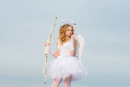 穿着白色天使礼服,戴着光环的天使女孩.丘比特小女孩的肖像.爱之神.