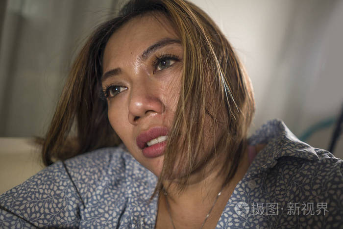 年轻美丽悲伤抑郁的女人在家沙发上思绪万千迷茫心碎饱受抑郁危机和
