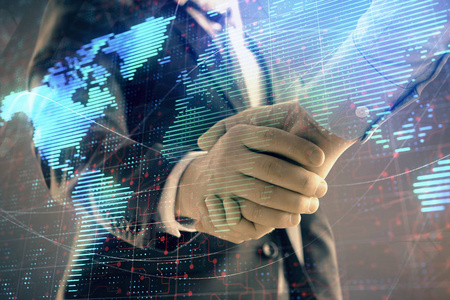 两位商人握手,在抽象背景下多次曝光世界地图.国际商务概念照片