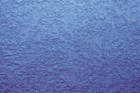 蓝色的水泥墙,粗糙的表面看起来像蓝色沙子.背景纹理设计.