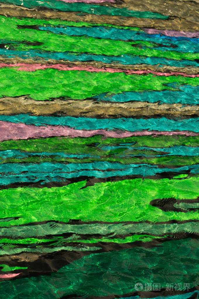 彩色泳池水抽象背景用波纹的水把游泳池的底部涂上颜色