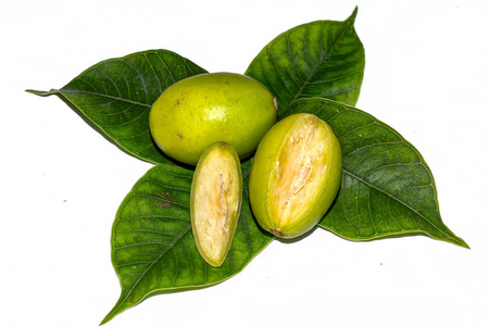 叶杜果在白色隔离背景上切下带绿色叶子的新鲜海绵果.照片