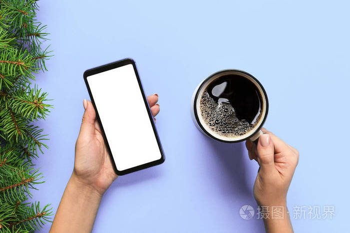 女性手拿黑色手机白色屏幕和咖啡杯带复制空间的模型图像俯视图蓝色