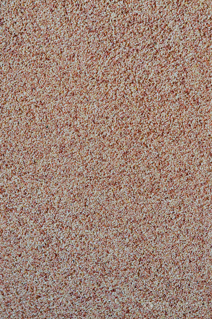 背景下散布着小沙砾石屑墙面的纹理浅色