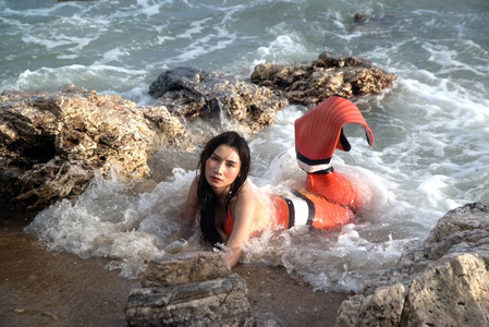 美丽的亚洲女子比基尼和美人鱼礼服在海滩上的乐趣.照片