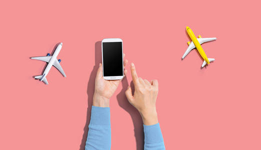 手持智能手机和飞机的人图片