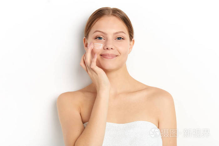 微笑的女孩按摩脸呵护皮肤