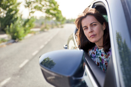 坐在汽车乘客座上的女人照片